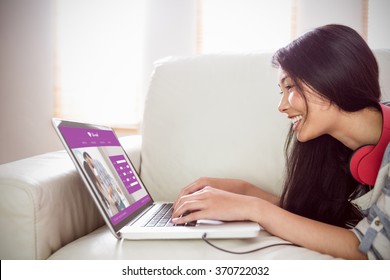 Online Dating App Against Smiling Asian Woman On Couch Using Laptop