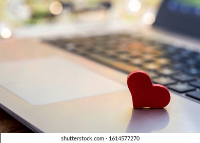 Online Dating concept with laptop red heart shape 