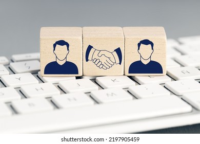 Online Deal Concept  Two Human Icon And Handshake Icon On Wooden Blocks On Computer Keyboard