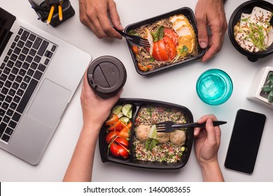 Online Delivery. Two Collegues Having Lunch Time Of Healthy Food In Office, Cellphone With Copy Space