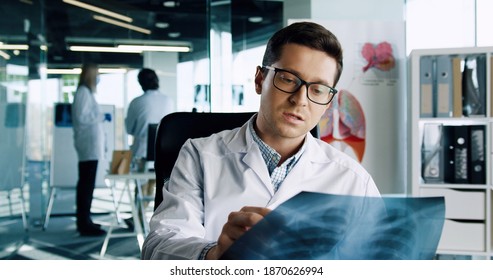 Online Doctor Consulting. Male Doctor Talking Directly To The Camera On Online Call With Patient Via Web Cam, Explaining And Discussing X-ray Scan. Telemedicine Concept. Medical Consultation. Close Up