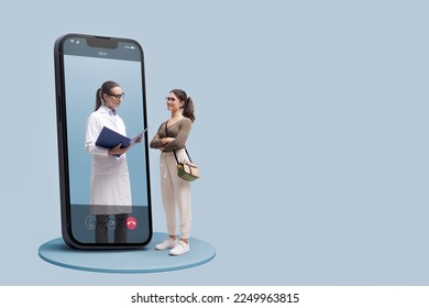 Online doctor taking care of a young patient, she is checking medical records, telemedicine concept - Powered by Shutterstock