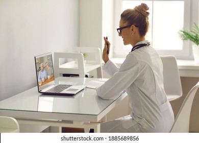 Online Doctor Video Calling Senior Patients. Family Practitioner Or Therapeutist Waving Hand At Laptop Computer, Greeting Aged Couple. Telemedicine, EHealth And Virtual Medical Consultation Concept