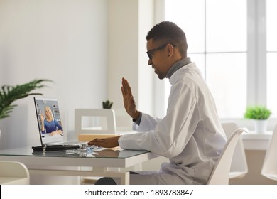 Online Doctor Video Calling Senior Patient. General Practitioner Or Therapeutist Waving Hand At Laptop Computer, Greeting Older Woman. Telemedicine, EHealth And Virtual Medical Consultation Concept