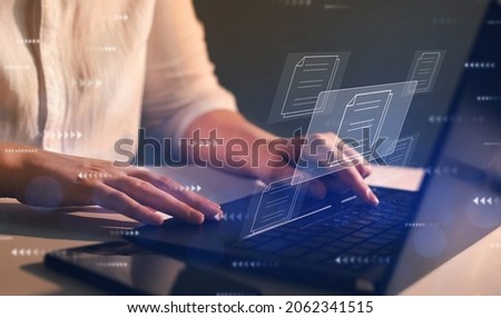 Online documentation database and  document management system concept. Businesswoman working on   laptop with virtual screen. Process automation to efficiently manage files. 