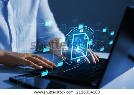 Online documentation database and document management system concept.	
Businesswoman working on laptop with virtual screen. Process automation to efficiently manage files. 