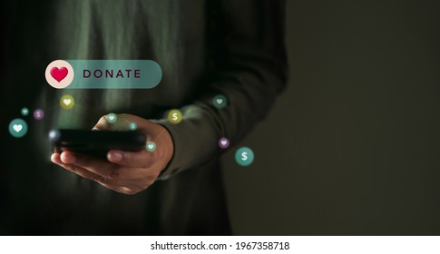 Online Donation, Volunteer and Charity Concept. Making Donate via Internet on Mobile Phone. Closeup shot - Shutterstock ID 1967358718