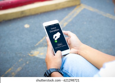Online Donation.Hipster Man Hands Holding Mobile Phone