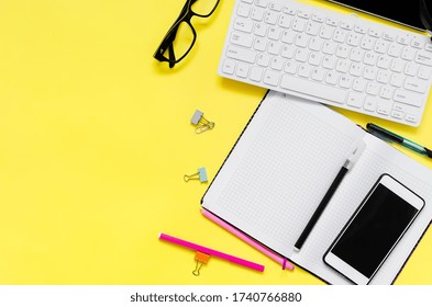 Online Education Concept. Tablet, Phone, Headphones, Notebook, School Supplies On Yellow Background. Distance School In Quarantine. View From Above With Copy Space. Mockup, Flatlay