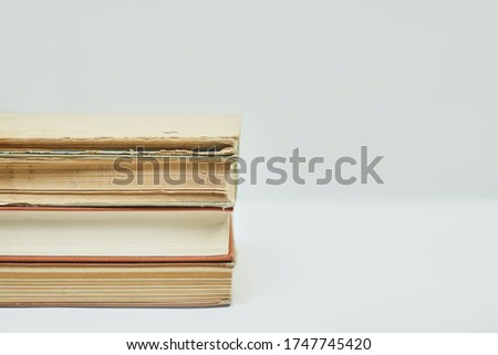 Online education or distance education concepts. Stack of old books on white with copy space