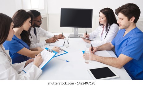 Online Education. Doctor And Interns Having Lecture And Taking Notes In Meeting Room
