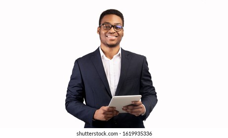 Online Education. Smiling afro man holding digital tablet and looking at camera over white studio background, copyspace - Powered by Shutterstock