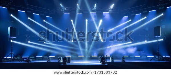 Online event entertainment concept. Background\
for online concert. Blue stage spotlights. Empty stage with blue\
spotlights. Blue stage lights. Online COVID-19 concert. Live\
streaming concert