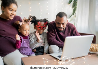 Online Family Reunion. Happy African American Family With Two Kids Making Engaging And Fun Video Call With Friends Or Grandparents During Winter Holidays At Home.  Online Celebrating. 