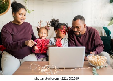 Online Family Reunion. Happy African American Family With Two Kids Making Engaging And Fun Video Call With Friends Or Grandparents During Winter Holidays At Home. Online Celebrating.