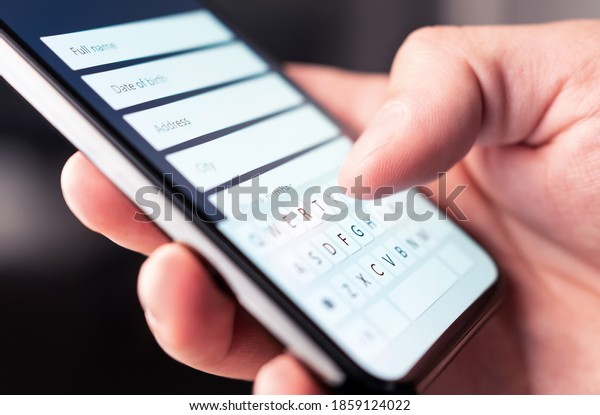 Online form to register personal info and data\
to web site with mobile phone. Person typing information to\
internet document, survey or questionnaire with smartphone.\
Customer registration to\
website.