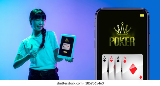 Online Gambling, Casino Concept. Young Asian Woman Holding Devices With Lottery, Casino Cover In Blue Neon Light. Flyer For Ad. Poker, Bookmaking, Gaming, Modern Technologies, Business And Finance.