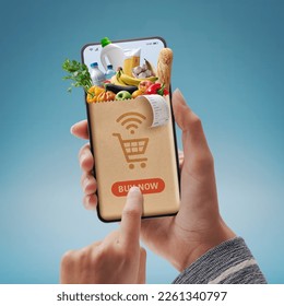 Online grocery shopping app: customer holding a smartphone and ordering groceries online - Powered by Shutterstock