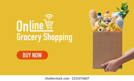 Online grocery shopping and home delivery: hands holding a box full of groceries - Shutterstock ID 2151476607