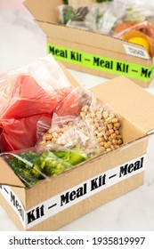 Online Home Food Delivery. Craft Box With Packed Tuna, Shrimp, Vegetables And Recipe Card On A Kitchen Background. Food Delivery Services During Coronavirus Pandemic And Social Distancing