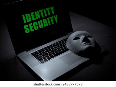 Online Identity Security concept - Laptop computer with mask to hide identity