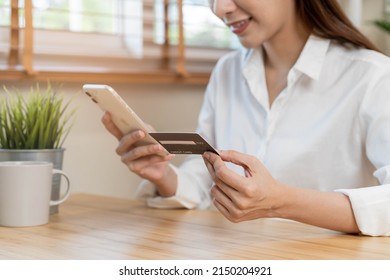 Online internet banking, asian young woman hand in payment spending by scan qr code, use phone, mobile to transfer money or pay money of credit card without cash at home. Technology of financial.