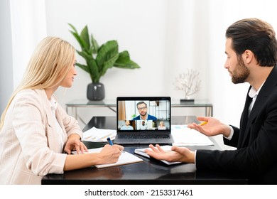 Online interview concept. Side view of the male and female is having online video meeting with pleasant colleagues on a laptop screen. Confident man is talking, an applicant is listening