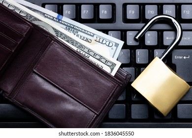 Online Investing Privacy Concept. Brown Leather Wallet And Golden Padlock On A Black Keyboard. Above View. Studio Shot.