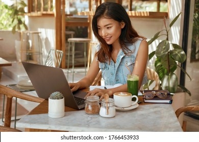 Online Job. Girl With Laptop At Cafe. Business Woman In Jeans Outfit Working At Coffee Shop Portrait. Digital Nomad Lifestyle For Remote Working Or Studying On Summer Vacation. 