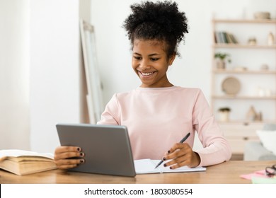 Online Learning. Cheerful Black Secondary School Student Girl Studying Using Digital Tablet At Home. Selective Focus