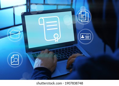 Online learning concept. Man using laptop with diploma illustration on screen surrounded by different icons, closeup