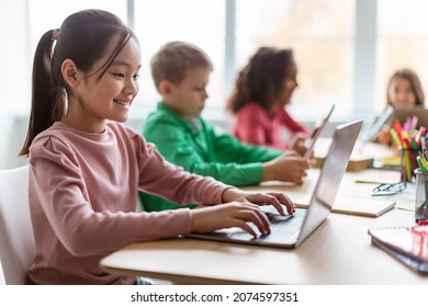 Online Learning. Diverse Children Using Laptop In Modern Classroom At School, Selective Focus On Happy Asian Schoolgirl Browsing Internet On Computer. E-Learning, Education And Technology - Powered by Shutterstock