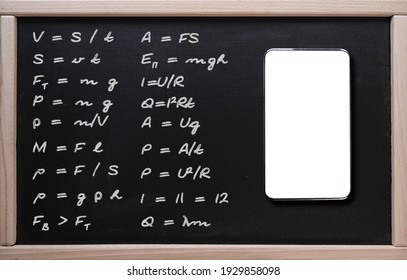 Online learning, math classes. Tablet on the background of a class board with written mathematical formulas