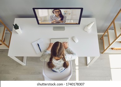 Online Learning School. Litle Girl Are Doing Online Education With A Teacher Using A Laptop Sitting At Home.