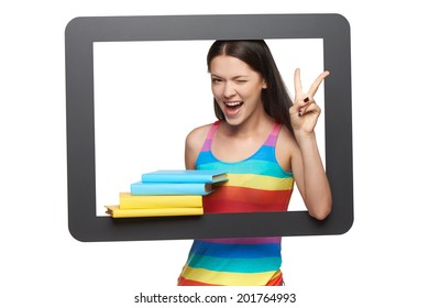 Online library concept. Happy young woman holding stack of books through tablet frame gesturing thumb up, over white background