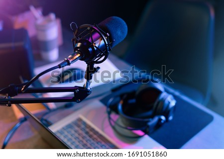 Online live radio studio desk with microphone in the foreground, entertainment and communication concept