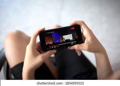 Online Live Seminar Or Webinar Concept.Woman Watching Live Stream Seminar Events Via Mobile Phone