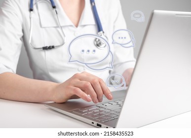 Online medical consultation. Doctor using laptop for chatting with patients remotely and giving answers about general health concerns. Woman with stethoscope sitting at table with computer. photo