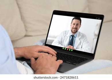 Online medical consultation. Man having video chat with doctor via laptop at home, closeup - Powered by Shutterstock