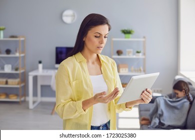 Online Medical Consultation. Parents And A Child Consult A Doctor Using A Tablet At Home.