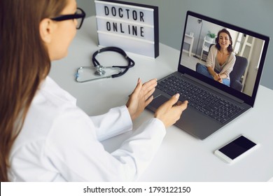 Online Medical Consultation. The Patient And The Doctor Are Talking To The Web Conferencing On The Laptop Remotely. Virtual Clinic Concept.