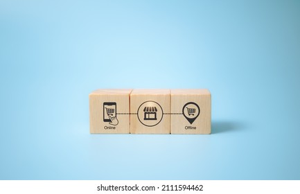 Online merge offline (OMO) concept. Borderless marketing channel conbination strategy create new opportunities, sales increase.  Wooden cubes; combination of online and offline icon, blue background.