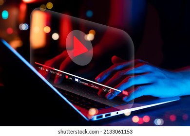 Online movie streaming with laptop computer, Young man watching a movie on a mobile phone with an imaginary video player service. - Shutterstock ID 2133061153