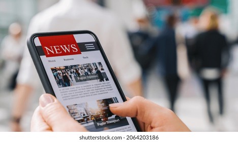 Online News On A Mobile Phone. Close Up Of Businesswoman Reading News Or Articles In A Smartphone Screen Application. Hand Holding Smart Device. Mockup Website. Newspaper And Portal On Internet.