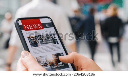 Online news on a mobile phone. Close up of businesswoman reading news or articles in a smartphone screen application. Hand holding smart device. Mockup website. Newspaper and portal on internet.