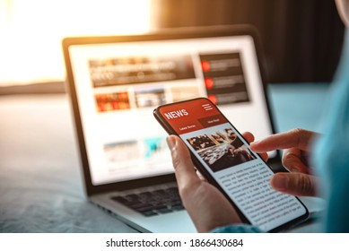Online news on a smartphone. Mockup website. Woman reading news or articles in a mobile phone screen application at home. Newspaper and portal on internet. - Shutterstock ID 1866430684