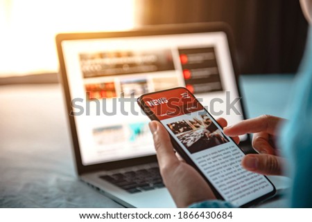 Online news on a smartphone. Mockup website. Woman reading news or articles in a mobile phone screen application at home. Newspaper and portal on internet.