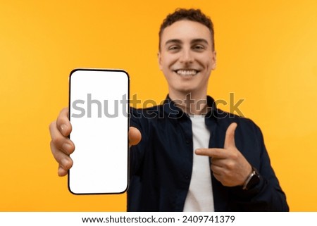 Online offer, great deal. Phone with white blank screen in man hand, mockup copy space for advertisement. Positive guy showing smartphone, recommending nice mobile app