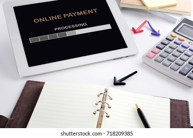 Online payment application processing on computer tablet on office desk