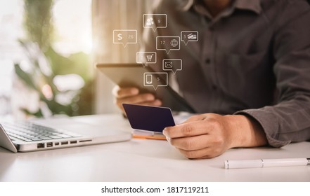 Online payment of hands of male holding smartphones and using credit cards and laptop computers for online shopping. - Shutterstock ID 1817119211